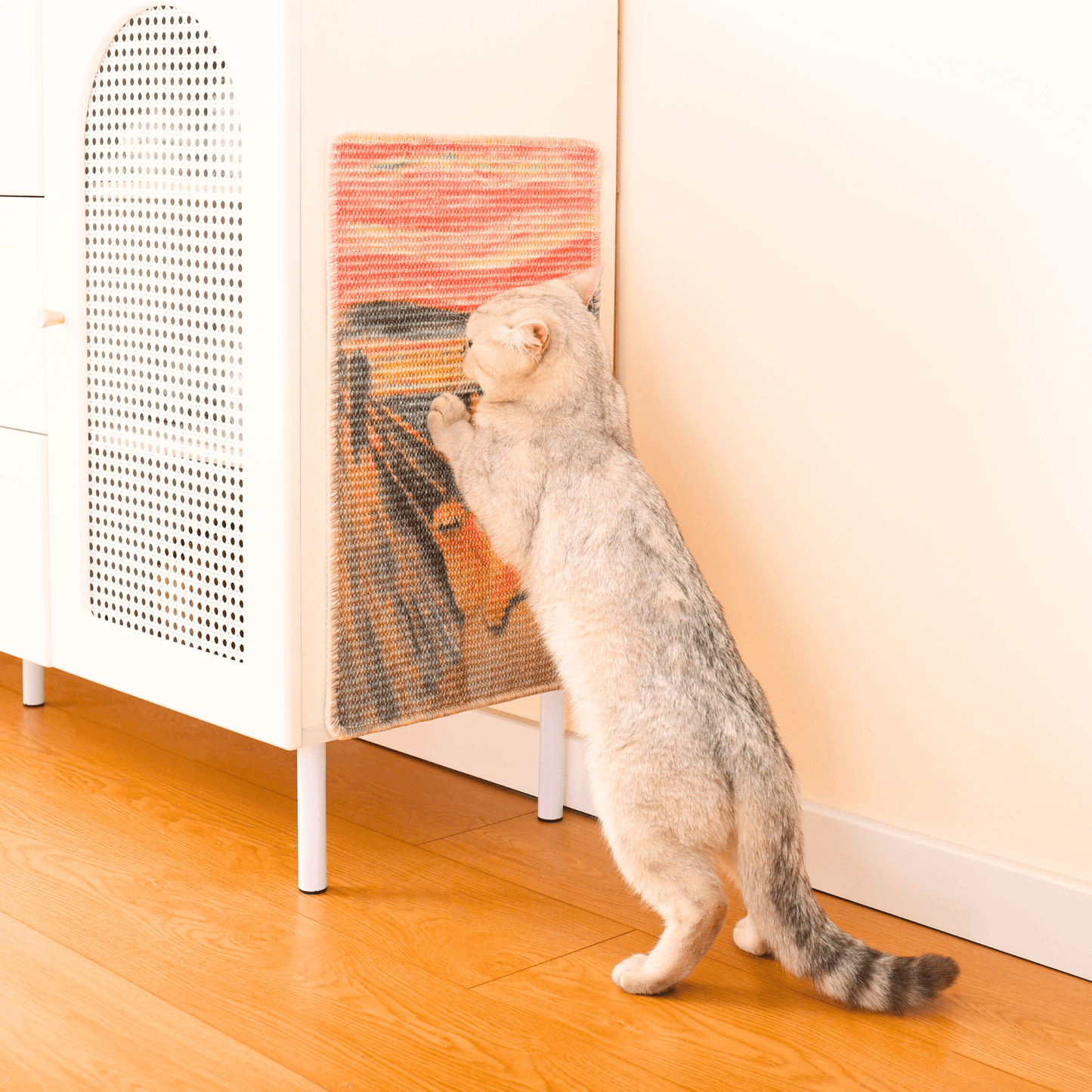 Cat enjoying the Art-Inspired Natural Sisal Scratching Mat against furniture in a cozy home setting.