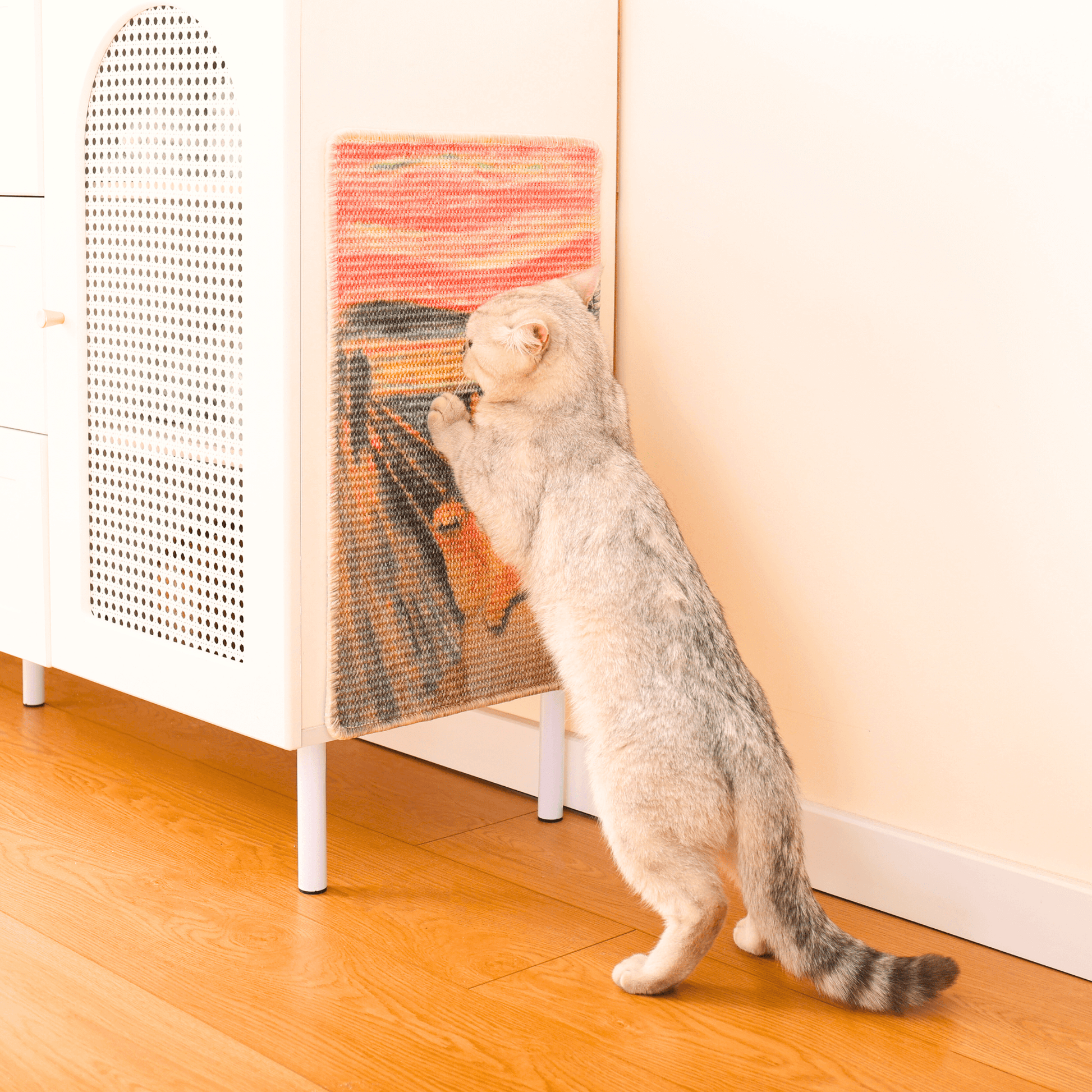 Cat enjoying the Art-Inspired Natural Sisal Scratching Mat against furniture in a cozy home setting.
