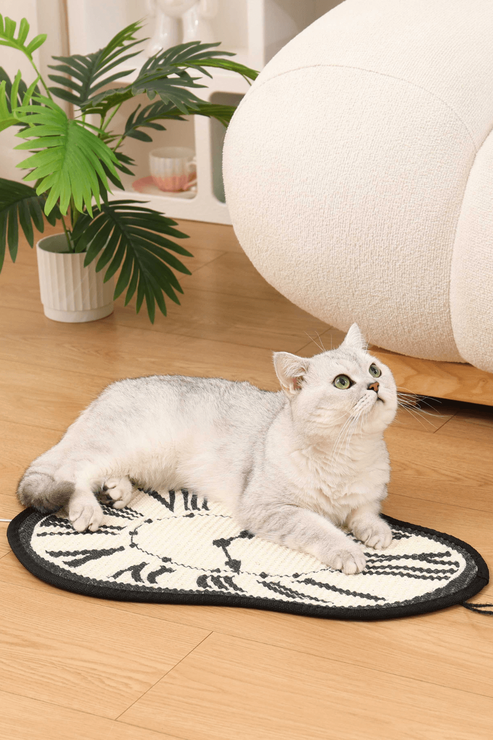 Cute cat relaxing on a Melting Clock Cat Scratching Mat with sisal surface and stylish design.