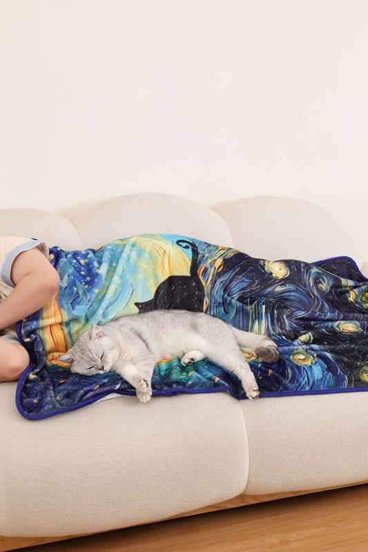 Cozy cat resting on a starry night pet blanket, showcasing its travel-friendly and soothing design.