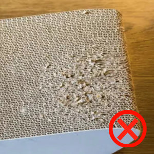 A super worn out cardboard scratcher leaving messy residues
