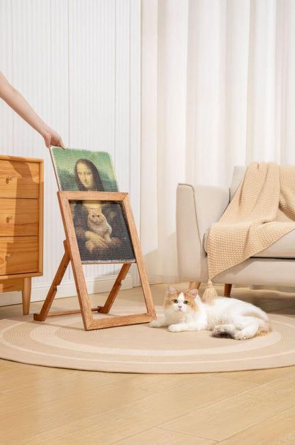 Cat enjoying the Ultimate Art Scratcher beside an art frame in a cozy living room setting.
